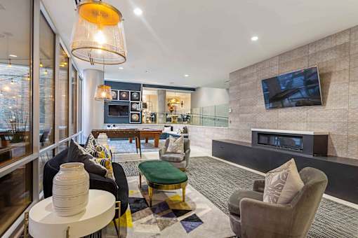 A modern living room with a fireplace and a flat screen TV mounted on the wall.