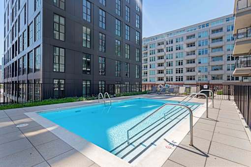 A swimming pool in front of a building.