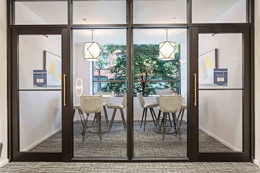 A glass door with a white frame separates two rooms.