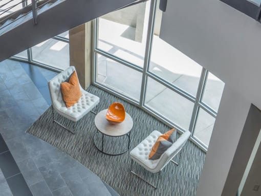 three chairs and a table in front of a window