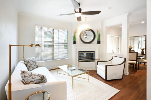a living room with a white couch and a fireplace
