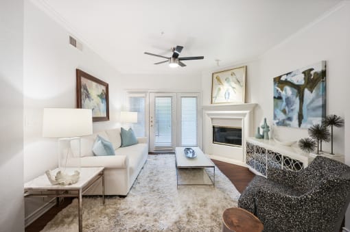 a living room with a white couch and a fireplace