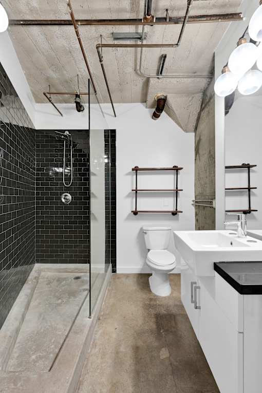 A bathroom with a white toilet and a walk-in shower.