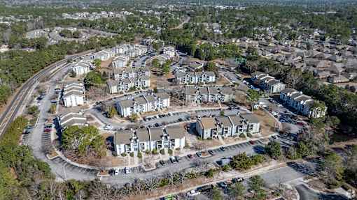 A bird's eye view of a residential area with houses and cars.