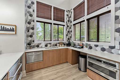A kitchen with a white counter top and wooden cabinets.