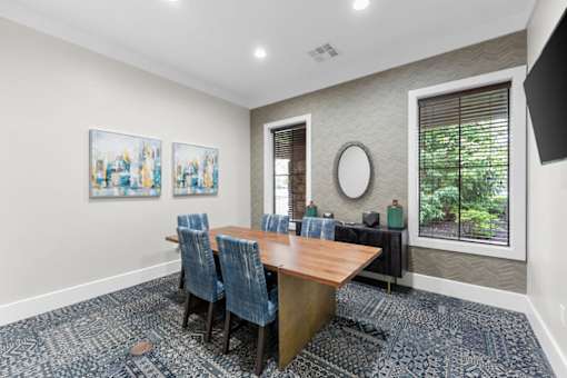 A conference room with a long table and chairs.