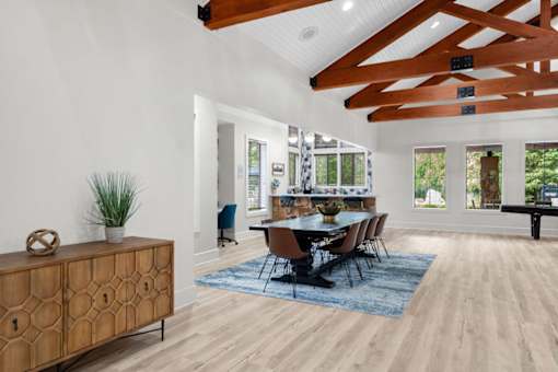 A dining room with a wooden table and chairs.