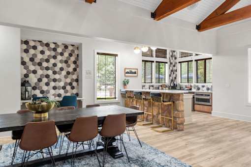 A dining room with a table and chairs.