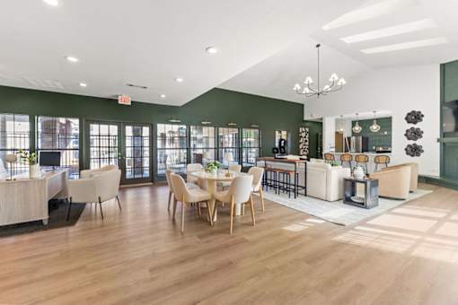 A spacious room with wooden floors and furniture.