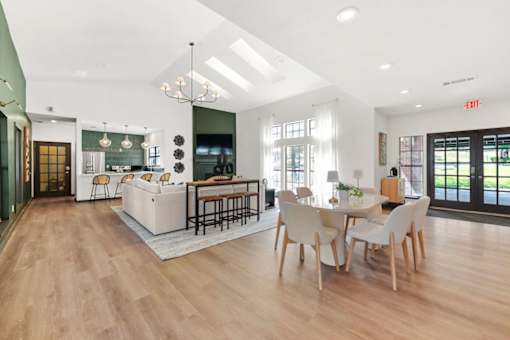 A modern kitchen with a dining table and chairs.