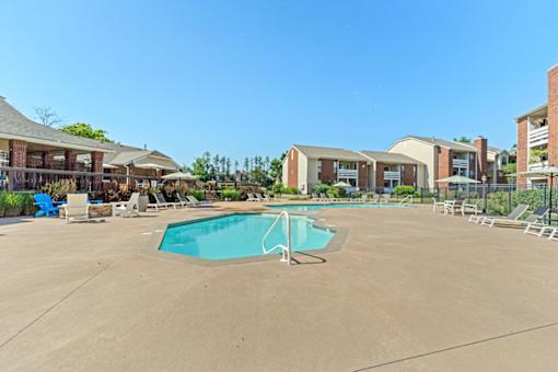A swimming pool in a sunny outdoor setting.