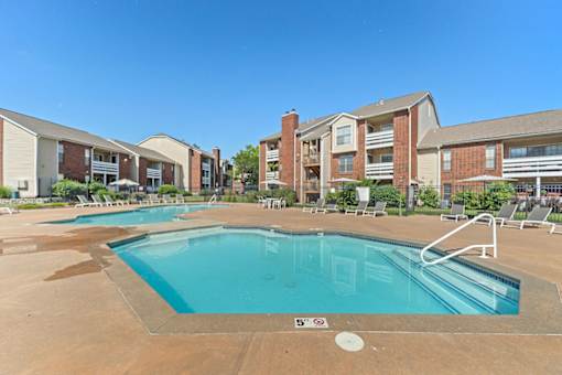 A swimming pool in front of apartment buildings.