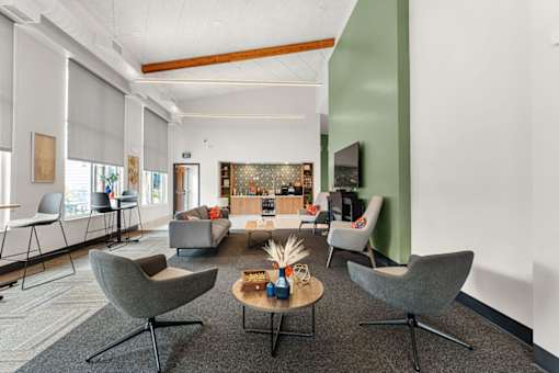 A living room with grey chairs and a coffee table.