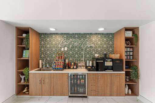 A kitchen with wooden cabinets and a green patterned backsplash.