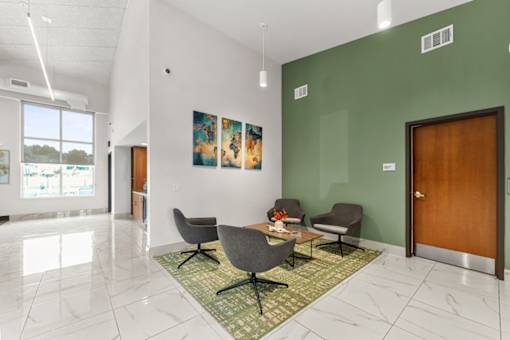 A room with a green wall and a wooden door.