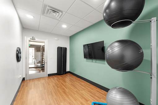 A room with exercise equipment and a flat screen TV.