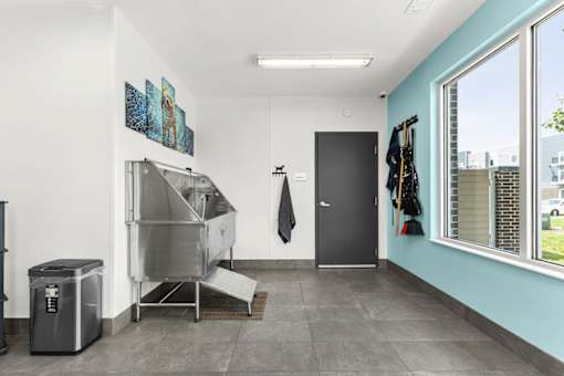 A kitchen with a large window and a sink.