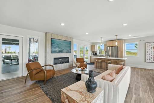 A modern living room with a large couch, a coffee table, and a fireplace.