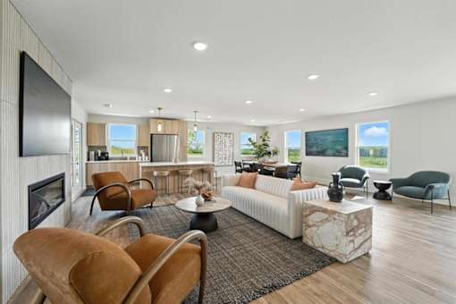 A modern living room with a fireplace and a large couch.