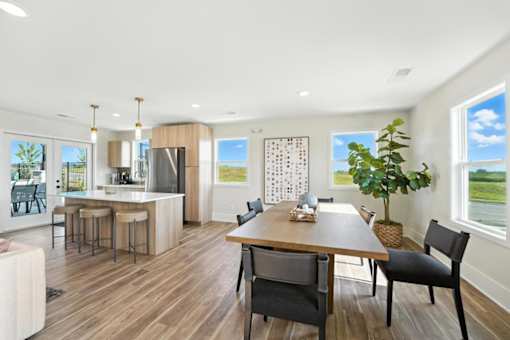 A modern kitchen with a dining table and chairs.