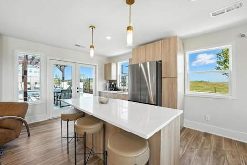 A modern kitchen with a bar area and a view of the outdoors.