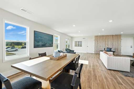 A modern dining room with a wooden table and chairs.