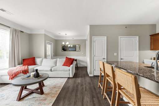 A living room with a white couch and a coffee table.