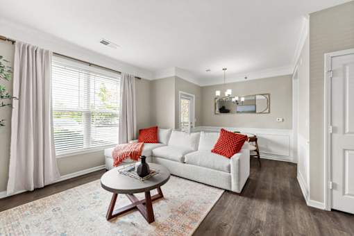 A living room with a white couch and a coffee table.