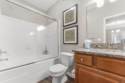A bathroom with a toilet, sink, and bathtub.