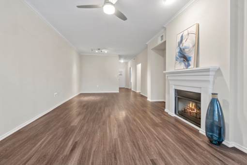 A long hallway with a fireplace and a painting on the wall.