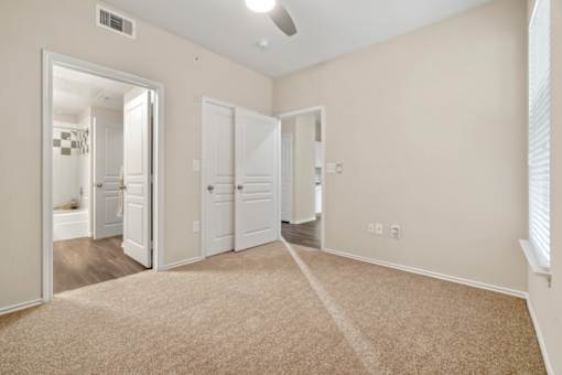 A room with a carpeted floor and white walls.