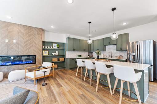 A modern kitchen with a bar area and a television.