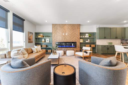 A modern living room with a grey sofa and a fireplace.