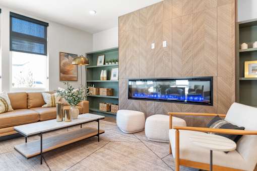 A modern living room with a large television and a sofa.
