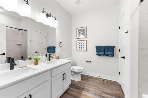 A white bathroom with a toilet and a sink.