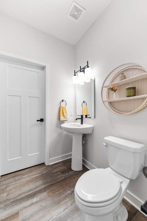 A white toilet sits next to a sink in a bathroom.