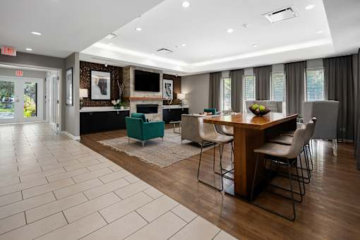 A modern dining room with a wooden table and chairs.