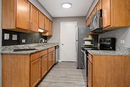 A kitchen with wooden cabinets and a white refrigerator.