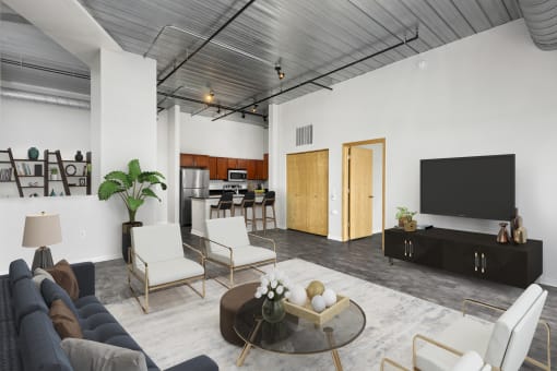 a living room with white walls and a wooden ceiling at The Bayshore Place Apartments in Glendale, WI