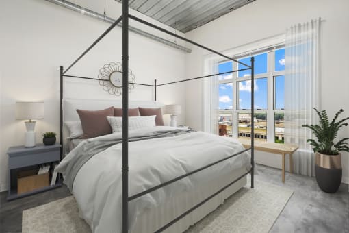 a bedroom with a bed and a window at The Bayshore Place Apartments in Glendale, WI