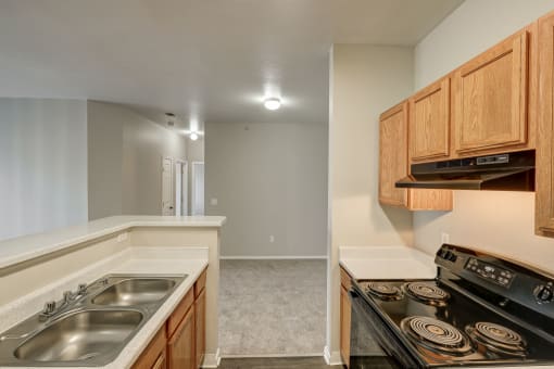 a kitchen with wood cabinets and a stove top oven and a sink