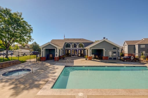 a swimming pool with a house in the background