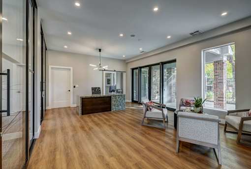 a living room with a couch and a desk and a window