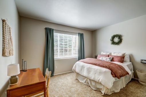 Bedroom with tall 9 ft ceilings, large window, beige carpeting
