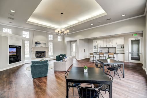 Sonoma Clubhouse with large windows, plank flooring, living room furniture and built in flat screen tv, large common area kitchen with seating