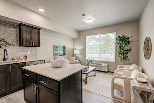 A kitchen with dark wood cabinets and a white countertop.