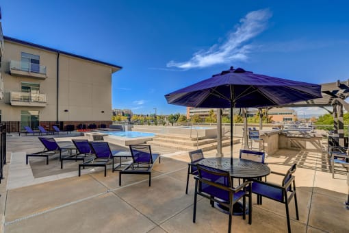 our apartments have a large patio with tables and chairs and a pool