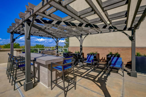 a patio with tables and chairs and a pergola