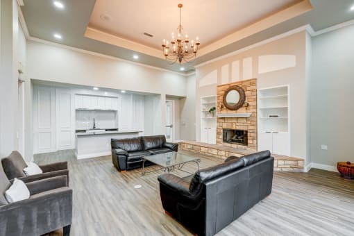 a living room with leather couches and a fireplace