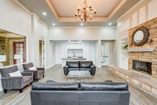 a living room with leather couches and a fireplace